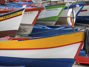 Close-up of several colourful fishing boats moored side by side in the harbour, Madeira, Portugal,