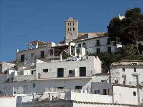A picturesque old town with white buildings and a church under a summer sky, ibiza, Spain, Europe