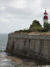 A lighthouse on the coast, surrounded by an old stone wall and the sea, Corsica, ajaccio, France,