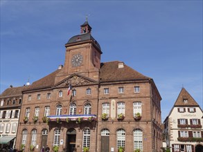 Historic half-timbered houses with floral decorations in Alsace, Wissembourg, France, Europe