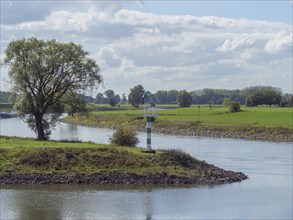 River landscape with green and white lighthouse and beautiful view of the surroundings in slightly