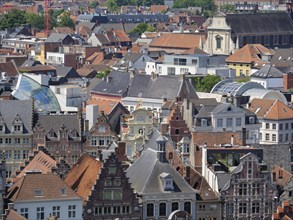 Overview of a city with colourful, historic houses and tiled roofs standing close together,