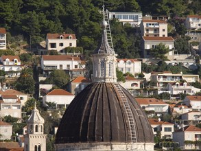 Large dome surrounded by traditional houses on a wooded hill, the old town of Dubrovnik with