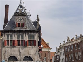 Historic building with gabled roof and red shutters in an old town, historic houses in Hoorn and