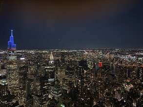 Night skyline of a city with illuminated skyscrapers and city lights, the skyline of new york with
