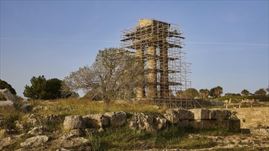 Acropolis of Rhodes, Ancient temple in ruins with scaffolding for restoration, surrounded by nature