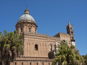 Majestic gothic cathedral with large dome and tower under a bright blue sky, historic cathedral