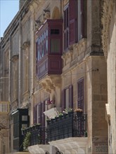 Row of buildings in the old town with decorative balconies and colourful shutters, the town of
