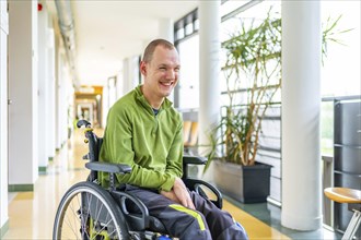 Portrait of a happy man in wheelchair with physical disability in the university