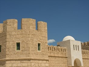 Close-up of a historic fortress with stone walls against a clear blue sky, Tunis in Africa with