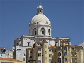 A large historic building with an impressive dome against a bright blue sky, Lisbon, Portugal,