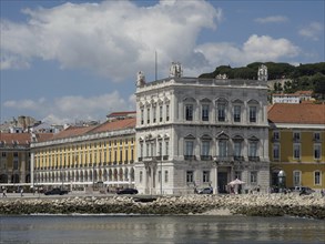Historic waterfront building with mixed weather, reflecting history and culture, Lisbon, Portugal,