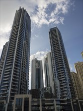Tall, modern buildings under a partly cloudy sky in Dubai, dubai, arab emirates