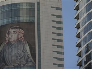 Skyscrapers with a large poster of a man in traditional dress, Abu Dhabi, United Arab Emirates,