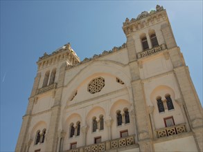 Front view of a large historic building with domes and beautiful decorations, Tunis in Africa with