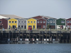 Colourful houses at the harbour reflected in the water, Heligoland, Germany, Europe