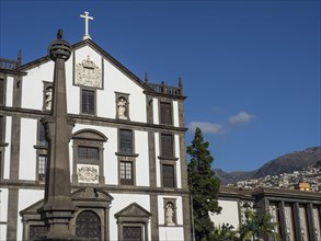 Historic church with ornate facade and mountains in the background, Madeira, Portugal, Europe