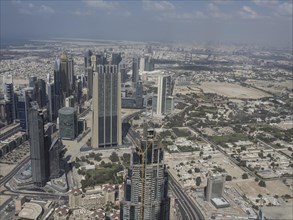 Panorama of Dubai with skyscrapers and modern buildings under a slightly cloudy sky, dubai, arab