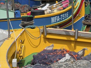 Close-up of colourful boats in the harbour, loaded with fishing nets, colourful boats in a historic