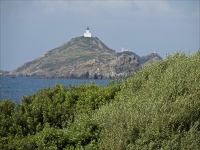 Lighthouse on a hilly, rocky cape overlooking the sea, Corsica, ajaccio, France, Europe