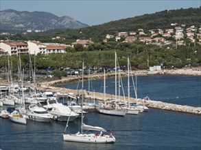 Marina with sailboats and mountains in the background in a picturesque coastal town, la seyne sur