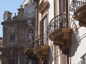 Close-up of balconies and sculptures on a baroque facade, palermo in sicily with an impressive