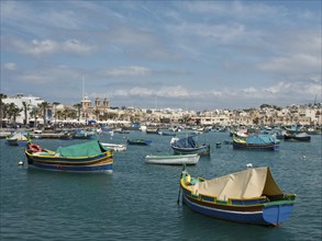 Panorama of a coastal town with colourful boats on the sea and clear sky, colourful boats in a