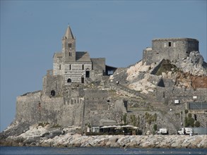 A stone church on a historic castle site on the sunny coast with a clear sky above, Bari, Italy,