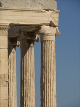 Detail of ancient doric columns in an old ruin, ancient columns in front of a blue sky, athens,