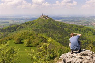Photographer taking pictures of Hohenzollern Castle near Hechingen, cloudy sky, Zollernalbkreis,