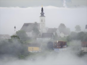 Church rises out of the morning mist, Frauenberg pilgrimage church, near Leibnitz, Styria, Austria,