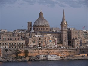 Close-up of the city dominated by the cathedral and a tower at dusk, Valetta, Malta, Europe