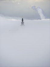 Church tower rises out of the morning mist, Frauenberg pilgrimage church, near Leibnitz, Styria,