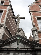 Statue of a crucifixion scene on a historical building under a cloudy sky, Historical Buildings,