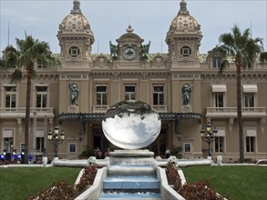 A magnificent palace with a mirror ball, surrounded by flowerbeds and a fountain, Monte Carlo,