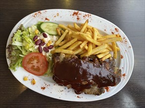 Spare ribs with chips and salad, tomato, on a plate, Food, Berlin, Germany, Europe