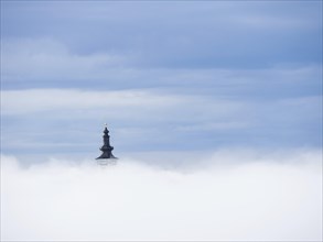 Church tower rises out of the morning mist, Frauenberg pilgrimage church, near Leibnitz, Styria,