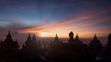 Buddha statue at sunrise, Borobudur temple complex, Borobudur, Yogyakarta, Java, Indonesia, Asia