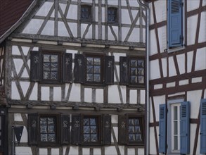 Close-up of a half-timbered house with dark shutters and stylistic accents, historic half-timbered