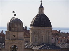 Historic towers and domes against a backdrop of roofscape and sea, the old town of Dubrovnik with