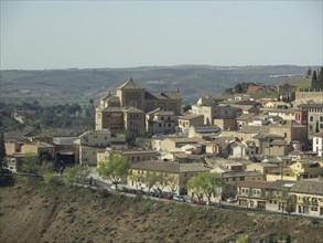 A village with traditional buildings on a hill in a picturesque landscape, toledo, spain