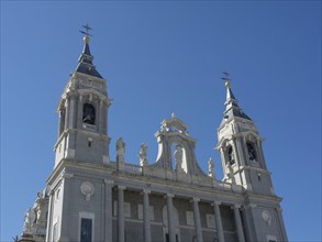 Front view of a church with high towers and detailed architectural decorations, Madrid, Spain,