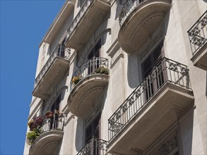 Close-up of a building with decorative balconies and a clear blue sky, palermo in sicily with an
