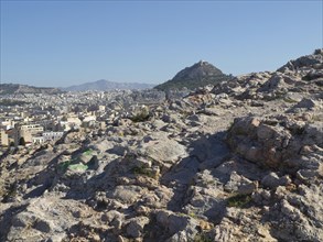 Stony landscape with a view of the city and surrounding hills, Ancient buildings with columns and