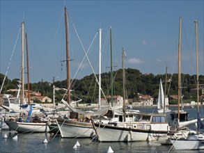 Sailboats anchored in a quiet harbour with a coastal town in the background, la seyne sur mer on