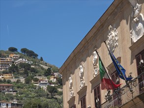 Italian and European flag building decorated and set in a hilly landscape on a sunny day, palermo