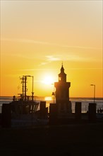 Pingelturm, historic lighthouse in the harbour, atmospheric, golden, beautiful sunset, silhouette