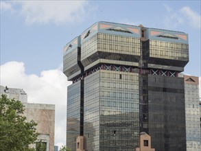 Modern high-rise building with glass facade and unique architecture under a clear sky, Lisbon,