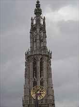 Detailed view of a Gothic clock tower with a large clock on a cloudy day, Historical Buildings,