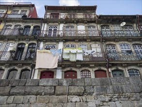 Close-up of historic buildings with ornate balconies with laundry hanging from them and an old